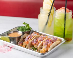Seafood Taco Trio, deep-fried shrimp, oyster, and white fish tacos. Stairway to lemon and Honu Kai Float cocktails.